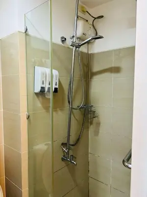 a shower with a glass door in a bathroom at SMDC SHORE 1 Residences, TOWER A in Manila