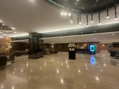 a lobby with a large lobby with couches and a television at Shore Residences Apartment Condo Staycation in Manila
