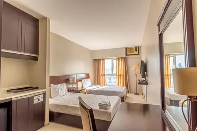 a small room with two beds and a table at Twin Bed Hotel Type by Ph Philstay in Manila