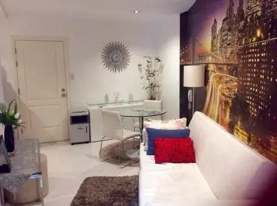 a living room with a white couch and a table at New York- Inspired Condo in Makati in Manila