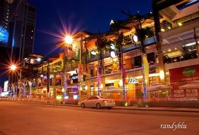 a white car parked in front of a building at night at New York- Inspired Condo in Makati in Manila