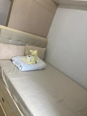 a stuffed animal is sitting on a bed at Theresa Sea Residence Tower EF in Manila