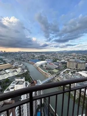 a view of a river from a balcony at Cozy Place near Eastwood in Manila