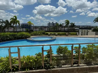 a large swimming pool on top of a building at Cozy Place near Eastwood in Manila