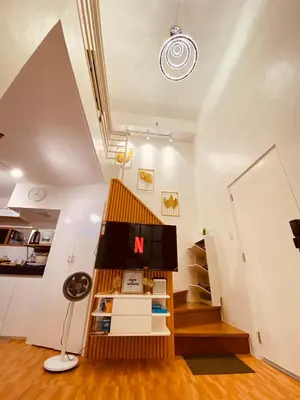 a small house with a staircase in a room at Cozy SpaciousLoft near MRT BONI in Manila