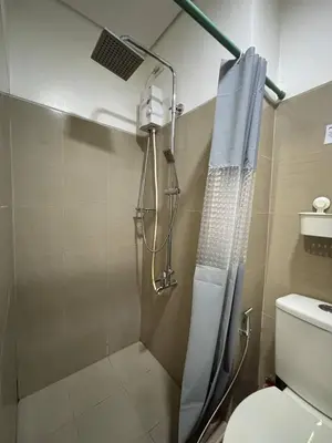 a shower in a bathroom with a toilet at Condo in Pasay in Manila