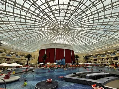 a large indoor swimming pool with a domed ceiling at 175 Sqm Luxurious Modern 3 Bedrooms Facing Manila Bay Sunset, Airports, Okada, Solaire, MOA in Manila