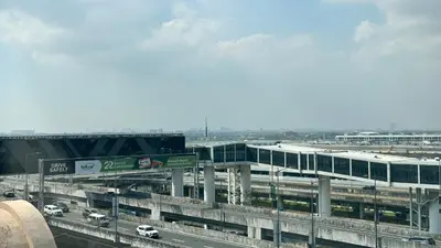 a freeway with a building and a highway with cars at Newport City across NAIA Terminal 3 by II JDs Aparthotel in Manila