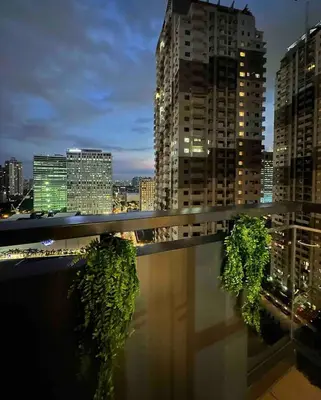 a view of a city at night with tall buildings at Studio in Araneta City Fast Wifi Great Location in QC in Manila