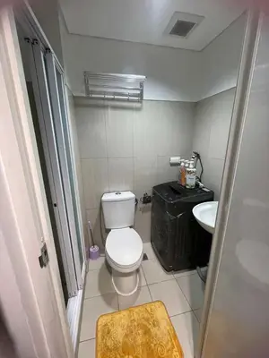 a small bathroom with a toilet and a sink at 1553 moa view bigcut in Manila