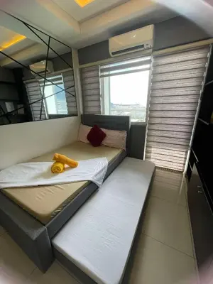 a room with a bed with a banana peel on it at 1553 Moa view bigcut in Manila