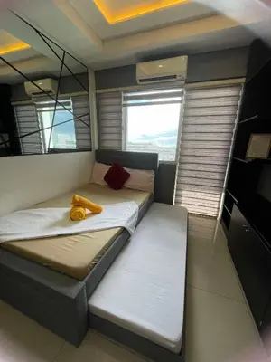 a bedroom with a bed with a yellow banana on it at 1553 Moa view bigcut in Manila