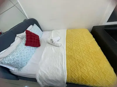 a bed with blankets and pillows on it at 1553 Moa view bigcut in Manila