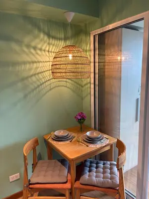 a table and two chairs with plates and bowls on it at Affordable Cozy Plage by Martian in Manila