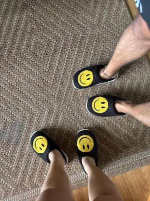 a person wearing black socks with yellow smileys on their feet at Affordable Cozy Plage by Martian in Manila
