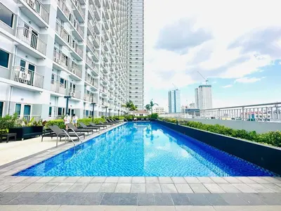 a swimming pool in the middle of a building at 2BR Solana Suite 4 at Coast Residences in Manila