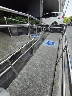 a metal railing in front of a building at 1BR Solana Suite 5 at Coast Residences in Manila