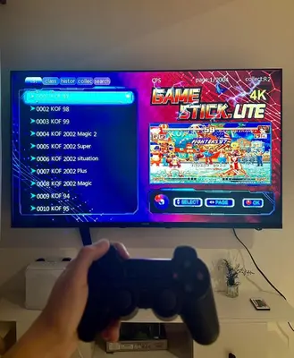 a person holding a video game controller in front of a tv at Azure Urban Resort Residences in Manila