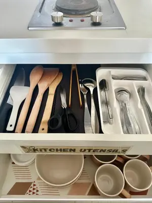 a drawer filled with utensils in a refrigerator at Azure Urban Resort Residences in Manila