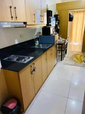 a kitchen with a sink and a counter top at 333D- 1br 1folding bed pool view in Manila