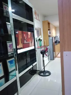 a room with a glass wall with a television in it at 257 moa view with balcony bigcut in Manila