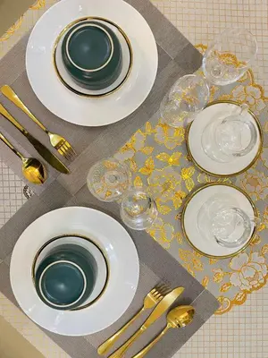 a table with plates and silverware on a table at Orchids Shore Residences Direct Pool Access in Manila
