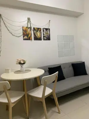a living room with a table and a couch at Sea Residence in Manila