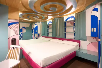 a bedroom with a bed with a circular ceiling at Victoria Court Las Pinas in Manila