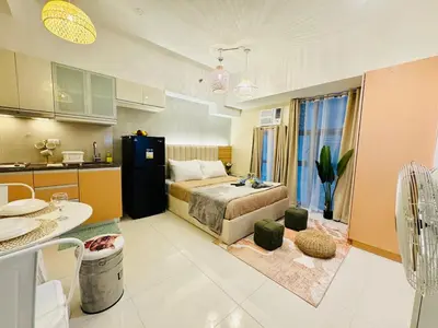 a large room with a bed and a kitchen at Staycation near Venice Mall mckinley taguig in Manila