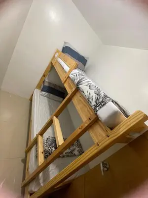 a wooden bunk bed in a room at Moa view with big balcony 558 in Manila