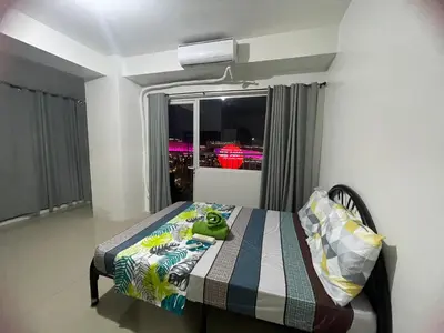 a bedroom with a bed with a stuffed frog on it at Moa view with big balcony 558 in Manila