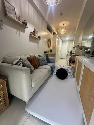 a living room with a couch and a table at Casa Alia at Coast - near MOA, US Embassy, PICC, WTC in Manila