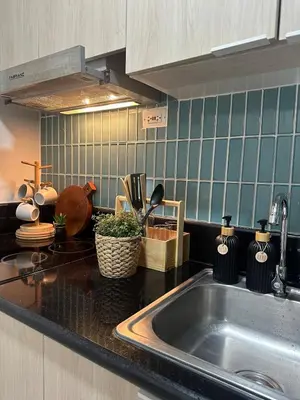 a kitchen with a sink and a counter top at Casa Alia at Coast - near MOA, US Embassy, PICC, WTC in Manila