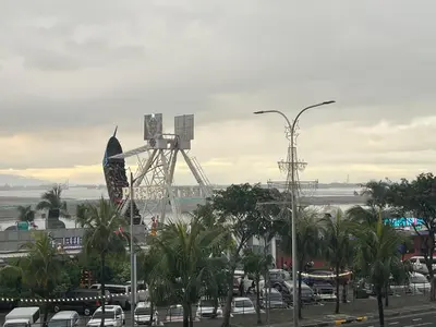 a view of a ferris wheel in a parking lot at Coast Residence Sea View Balcony WiFi Netflix Near MOA 1524 in Manila