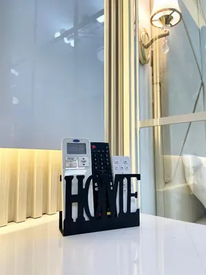 a phone sitting on a table next to a window at Luxury Condotel near MOA, NAIA in Manila