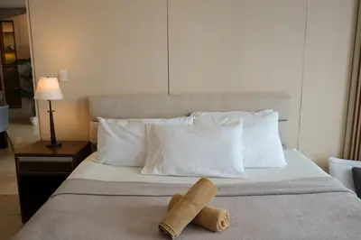 a hotel room with a bed with two towels on it at BGC One Uptown Premium 2BR Suite with Balcony near Supermarket, Malls and Restaurants in Manila
