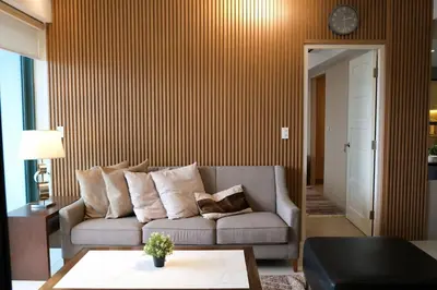 a living room with a couch and a table at BGC One Uptown Premium 2BR Suite with Balcony near Supermarket, Malls and Restaurants in Manila