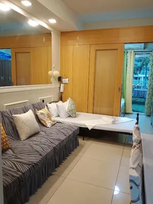 a room with two beds and a couch at 232D pool view with big balcony in Manila