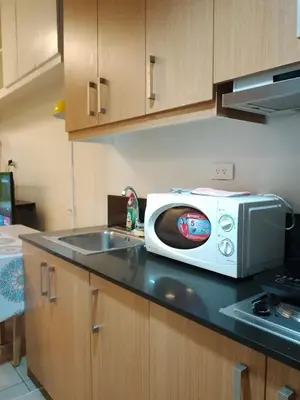 a white toaster oven sitting on top of a kitchen counter at 232D pool view with big balcony in Manila
