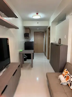 a large living room with a couch and a desk at Shore 3 Tower 3 1BD - MOA Complex in Manila