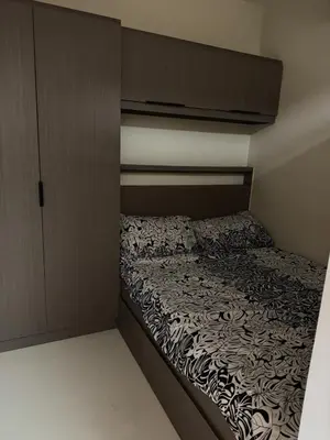 a small bed in a small room with at Shore 3 Tower 3 1BD - MOA Complex in Manila