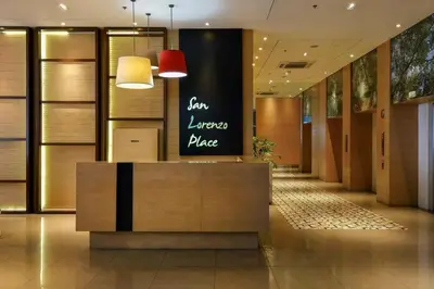 a lobby with a reception desk in a building at Staycation with city lights in Manila