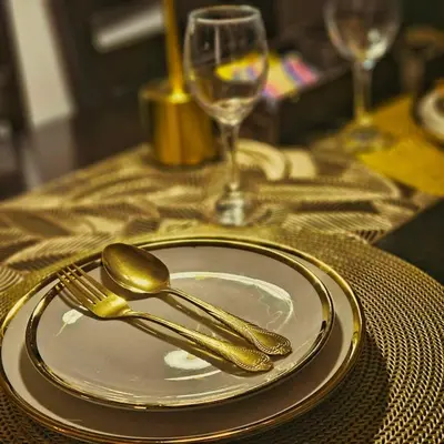 a table with a plate with a fork and spoon at Azure Urban Resort Staycation in Manila