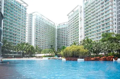 a large swimming pool in front of tall buildings at Azure Urban Resort Staycation in Manila