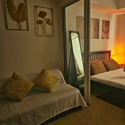 a bedroom with a mirror and a bed and a mirror at Azure Urban Resort Staycation in Manila
