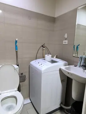 a small bathroom with a toilet and a sink at Shore B 524 in Manila