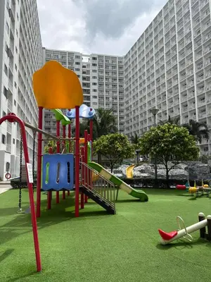 a playground in front of a large building at Shore B 524 in Manila