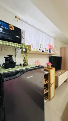 a kitchen with a stove and a counter top at Japanese Inspired Hotel at MOA in Manila