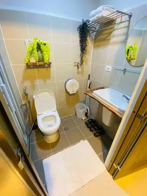 a bathroom with a toilet and a sink at 2 Bed's Unit at PICC Near MOA in Manila