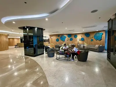 two people sitting in the lobby of a hotel at Hotel like Condo at Pasay in Manila